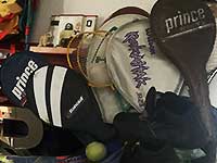 a close up photo of a selection of badminton and tennis raquets including covers