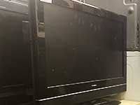 close up angled side view of a black secondhand LG tv for sale